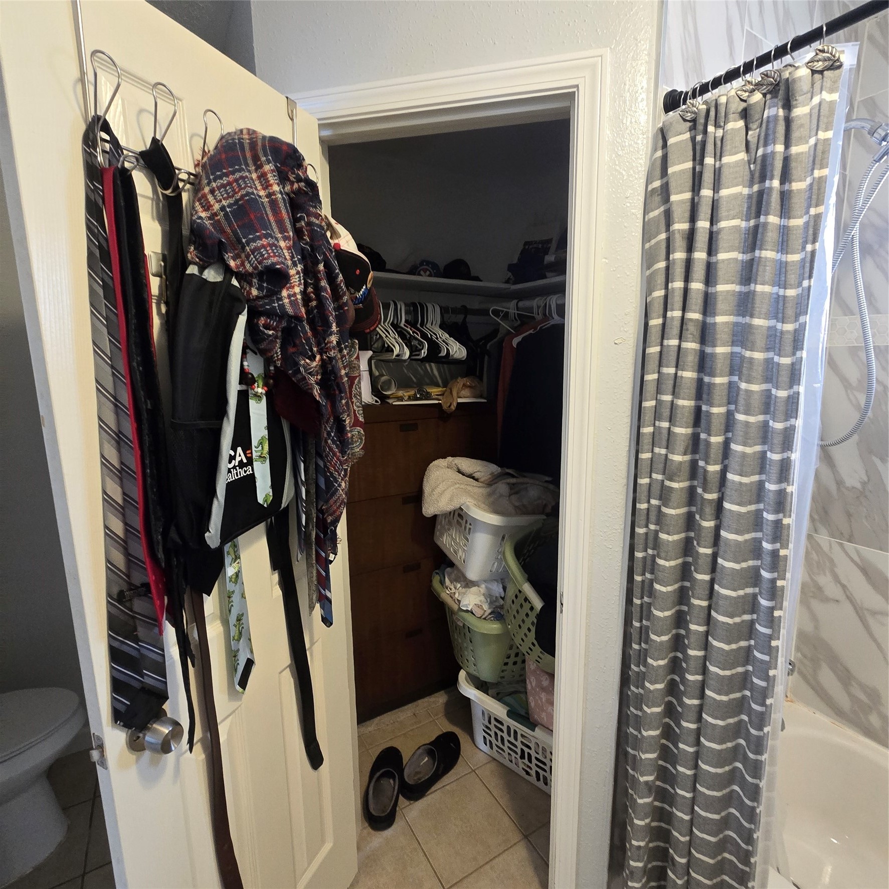 22527 Millgate Drive Spring, TX 77373 - Photo 18 of 30 a view of walk in closet with clothes and shoes