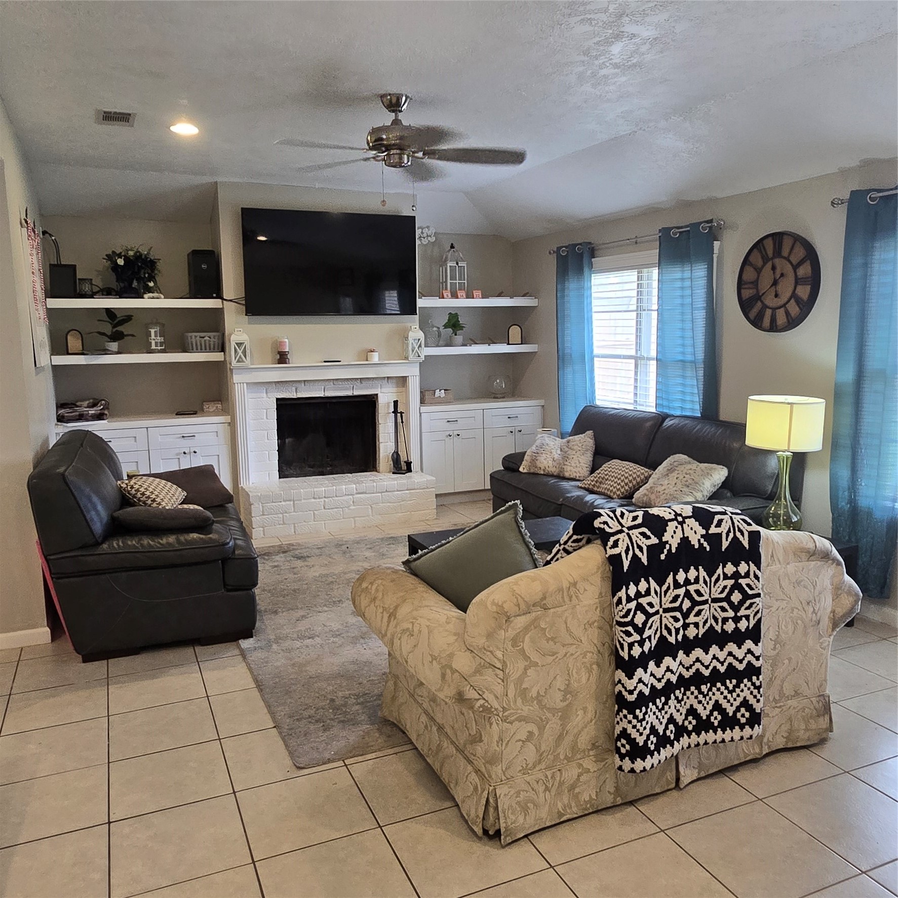 22527 Millgate Drive Spring, TX 77373 - Photo 6 of 30 a living room with furniture a flat screen tv and a fireplace