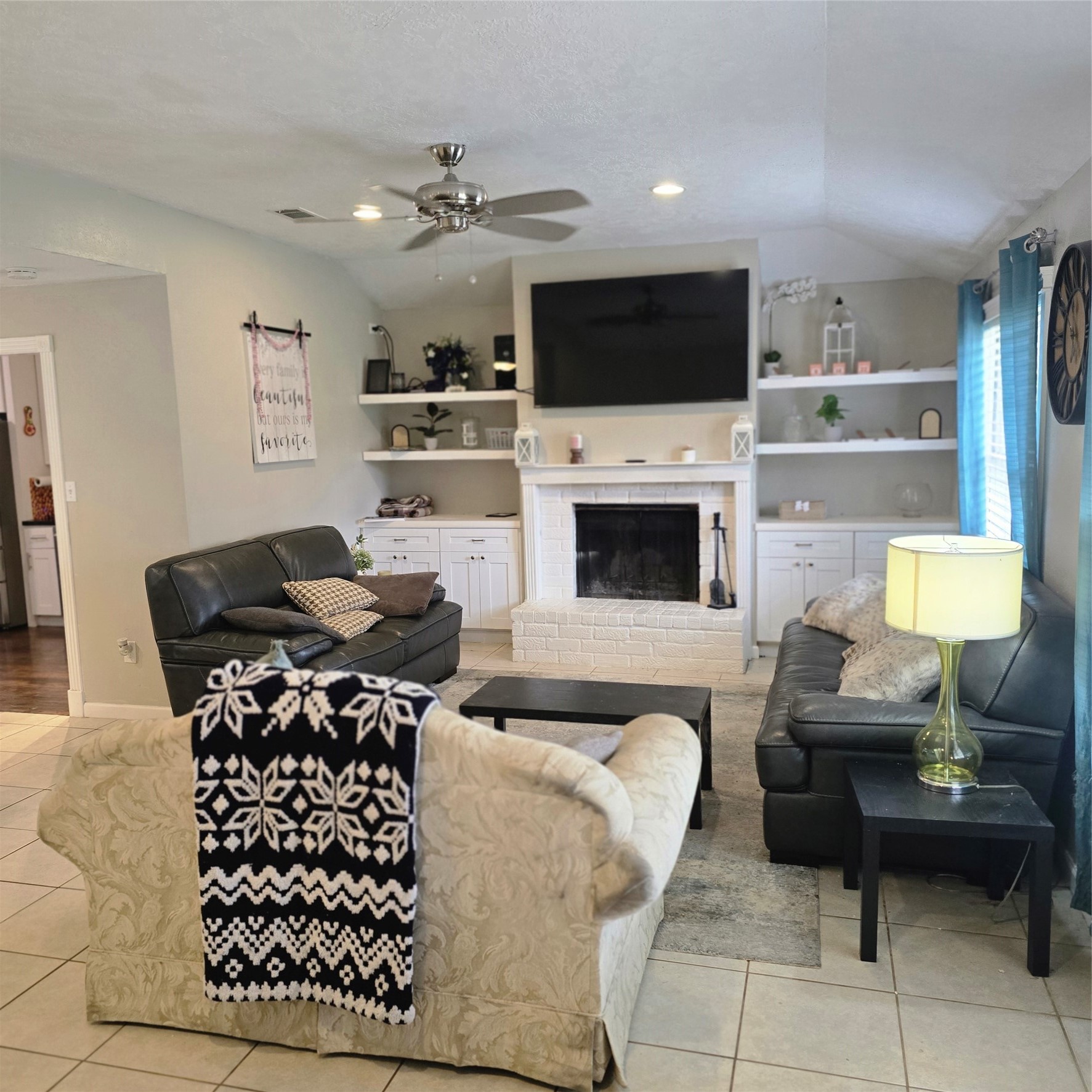 22527 Millgate Drive Spring, TX 77373 - Photo 7 of 30 a living room with furniture a flat screen tv and a fireplace