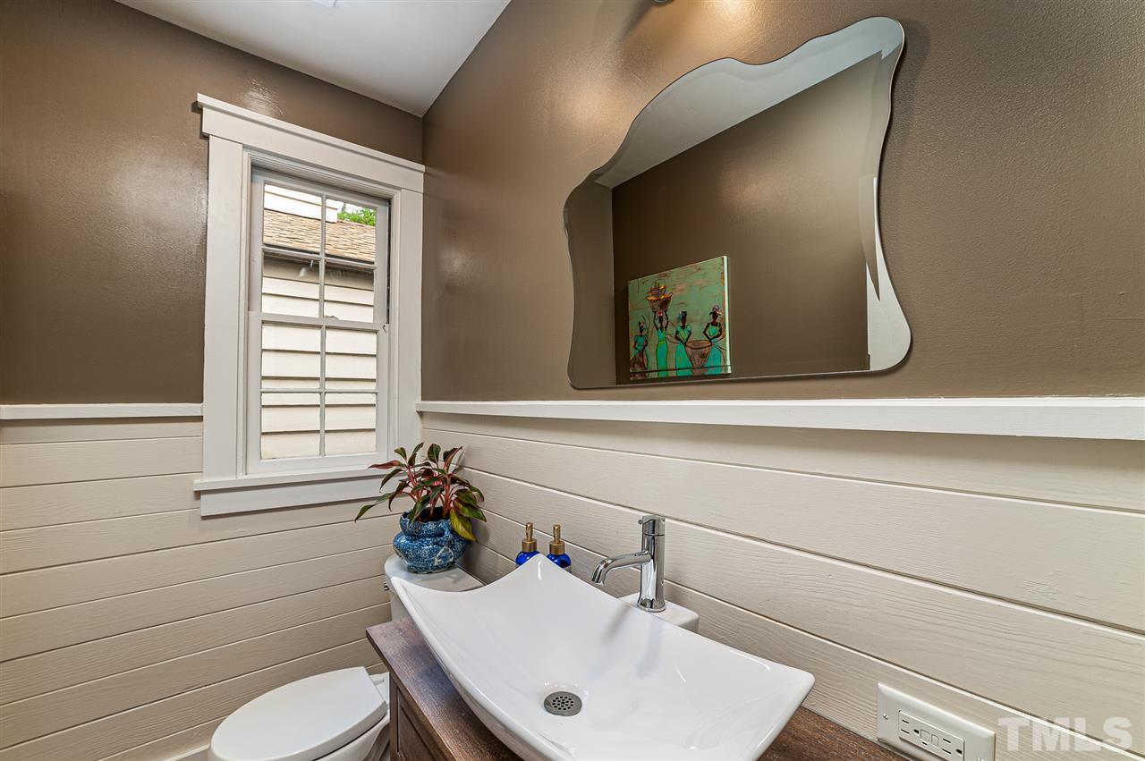 2251 Cranford Road Durham, NC 27705 - Photo 13 of 30 The Powder Bathroom offers a modern farmhouse vibe with horizontal shiplap walls, accent moulding and vessel bathroom sink. The bathroom is located off the Entry Foyer as you enter through the front door.