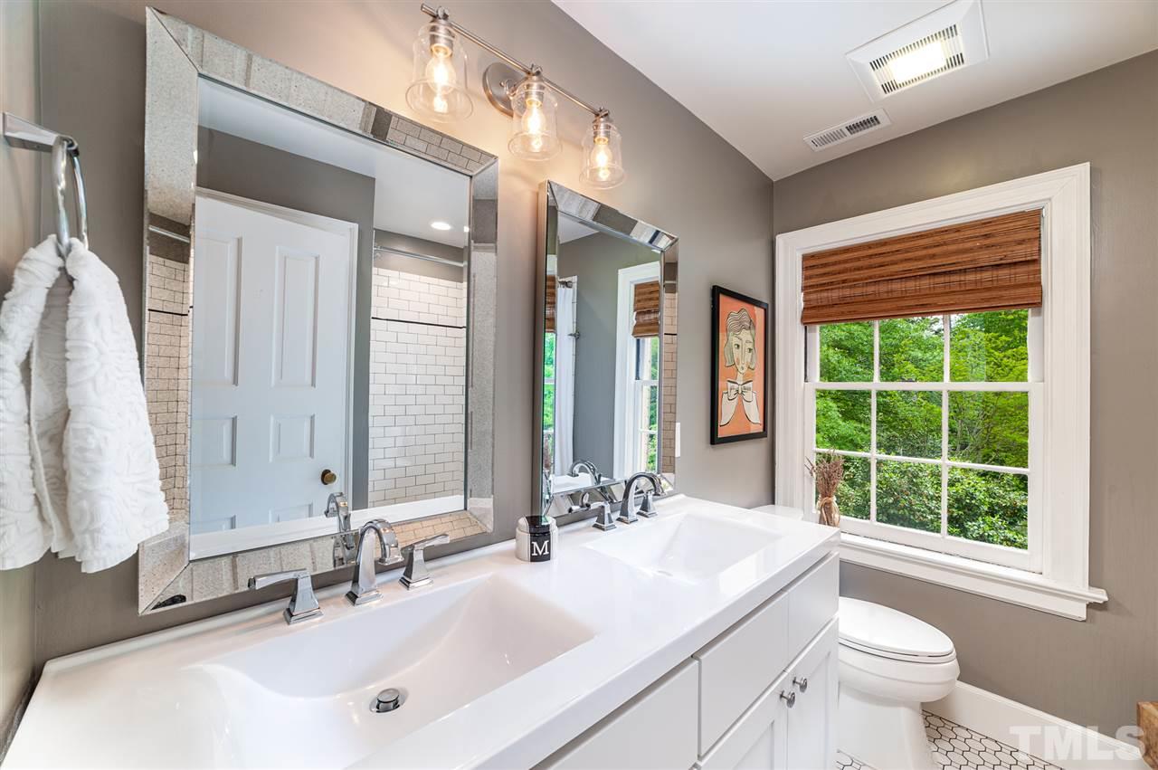 2251 Cranford Road Durham, NC 27705 - Photo 20 of 30 The Full Bathroom on the 2nd floor boasts classic tile flooring, shower/tub with subway tile surround, dual vanity and gorgeous mirrors with lighting.