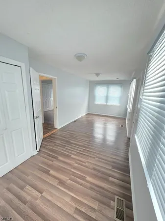 a view of a room with wooden floor and staircase