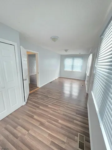 a view of a room with wooden floor and staircase
