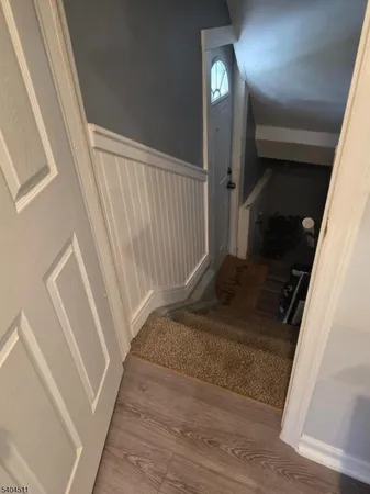 a view of staircase with white walls and railing