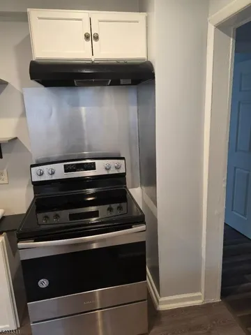 a stove top oven sitting inside of a kitchen