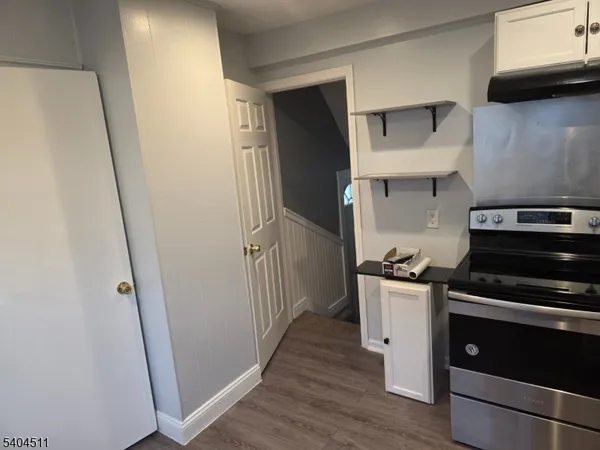 a kitchen with stainless steel appliances a stove a refrigerator and cabinets