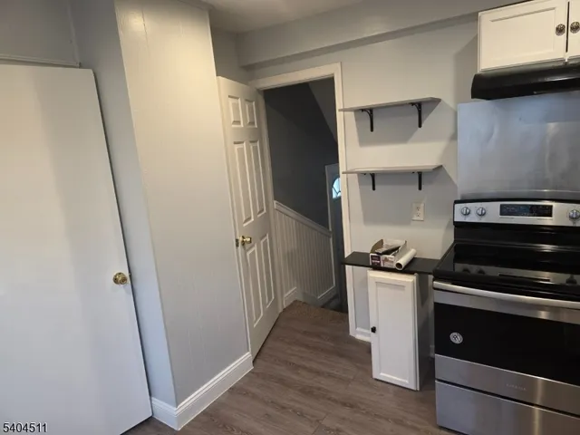 a kitchen with stainless steel appliances a stove a refrigerator and cabinets