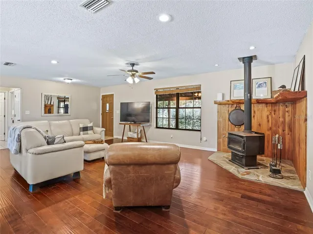 a living room with fireplace furniture and a flat screen tv