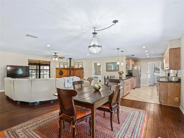 a view of a dining room with furniture wooden floor and chandelier