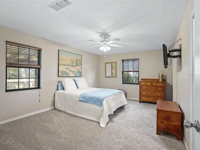 a spacious bedroom with a bed and a couch