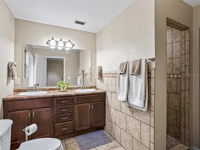 a bathroom with a double vanity sink and mirror