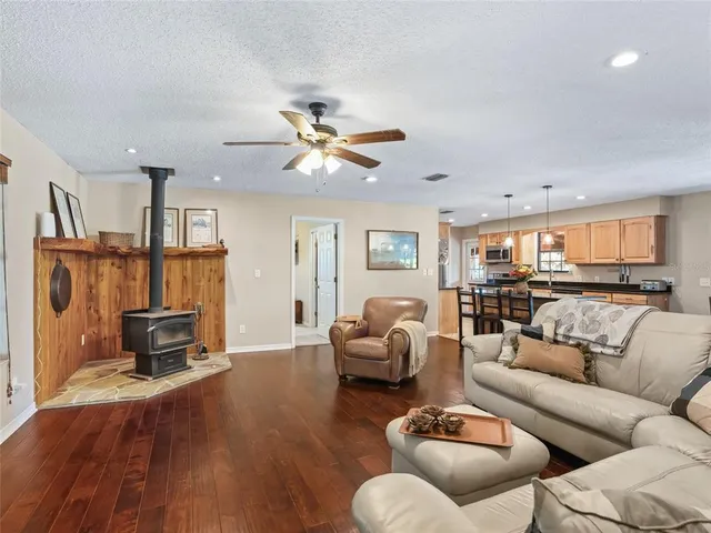 a living room with furniture and kitchen view