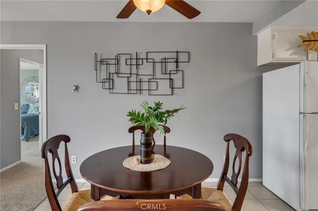 a dining room with furniture and a potted plant