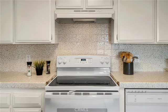 a stove top oven sitting inside of a kitchen
