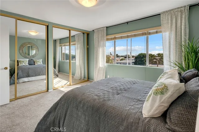 a bed sitting in a bedroom next to a window