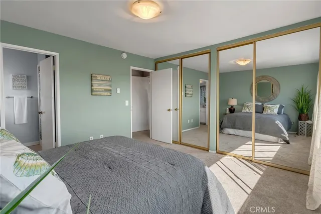 a bedroom with a bed and a glass door