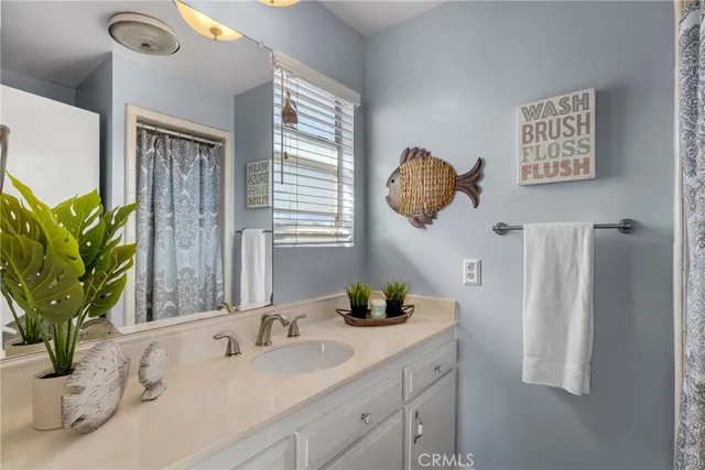 a bathroom with a tub sink and mirror