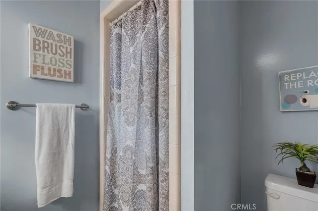 a bathroom with a shower curtain and a sink
