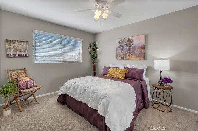 a bedroom with bed and a chandelier