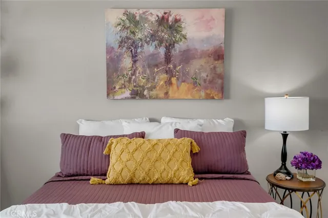 a living room with a couch and a potted plant