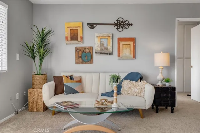 a living room with furniture and a potted plant