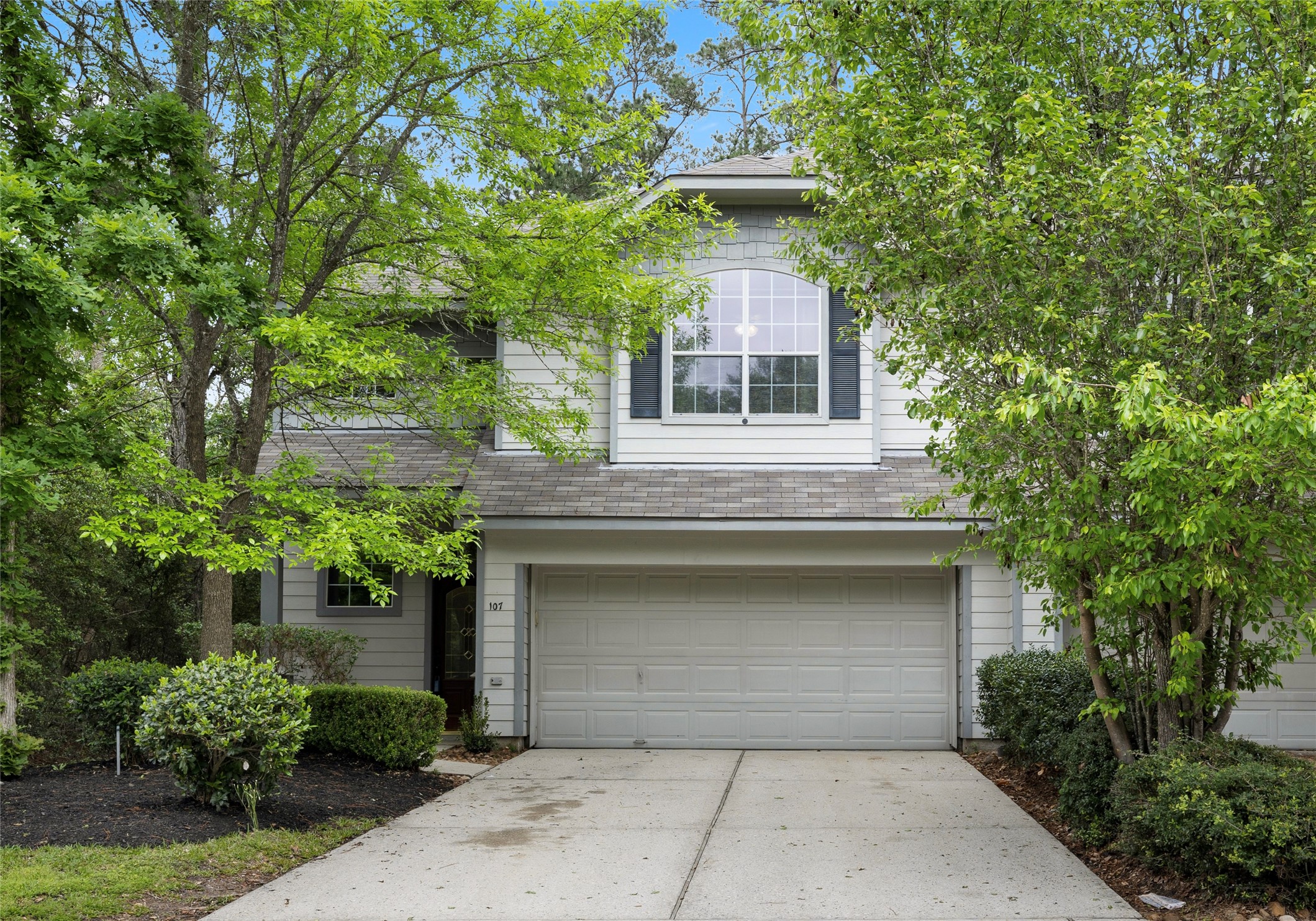 107 West Burberry Circle The Woodlands, TX 77384 - Photo 1 of 28 a front view of a house with plants