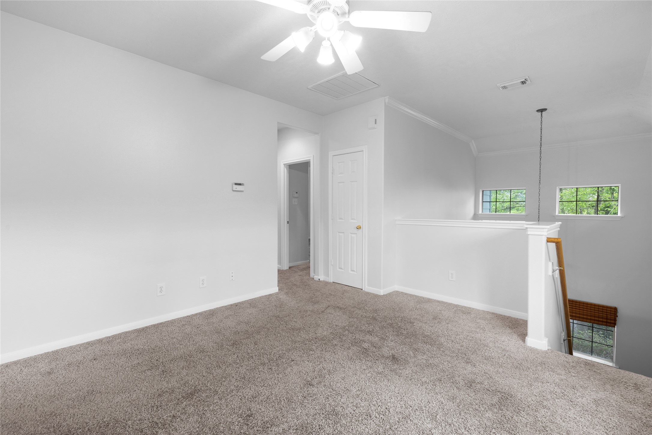 107 West Burberry Circle The Woodlands, TX 77384 - Photo 12 of 28 an empty room with windows and ceiling fan