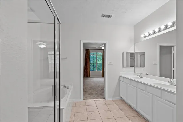 a bathroom with a bathtub and shower