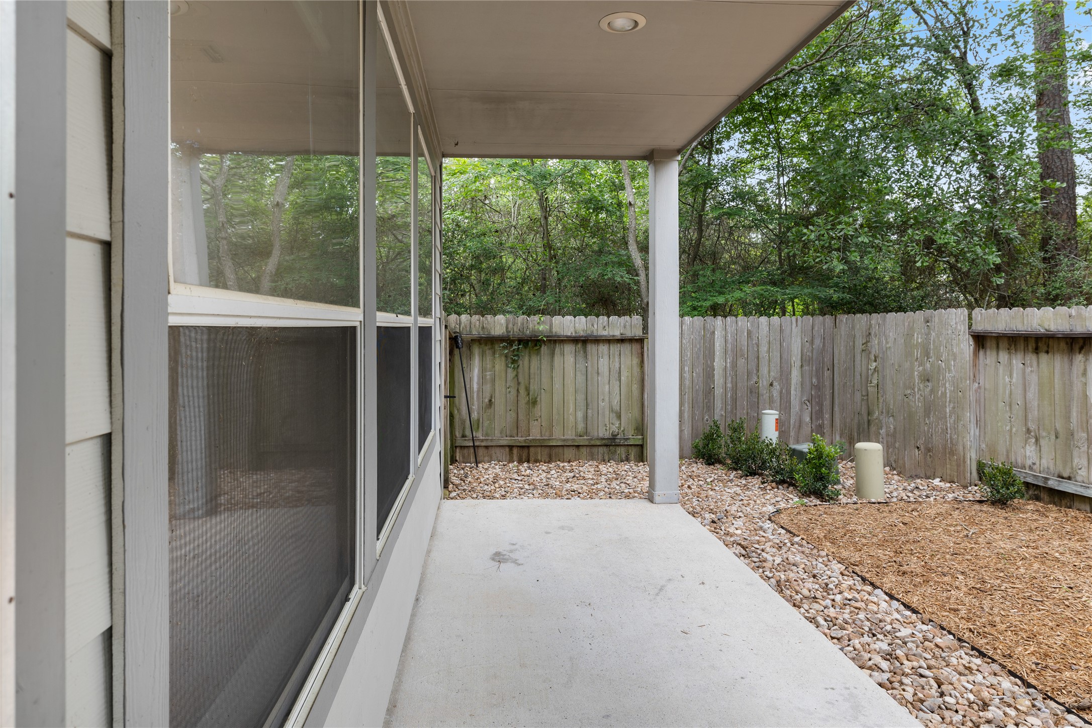 107 West Burberry Circle The Woodlands, TX 77384 - Photo 24 of 28 a backyard of a house with green floor and outdoor space