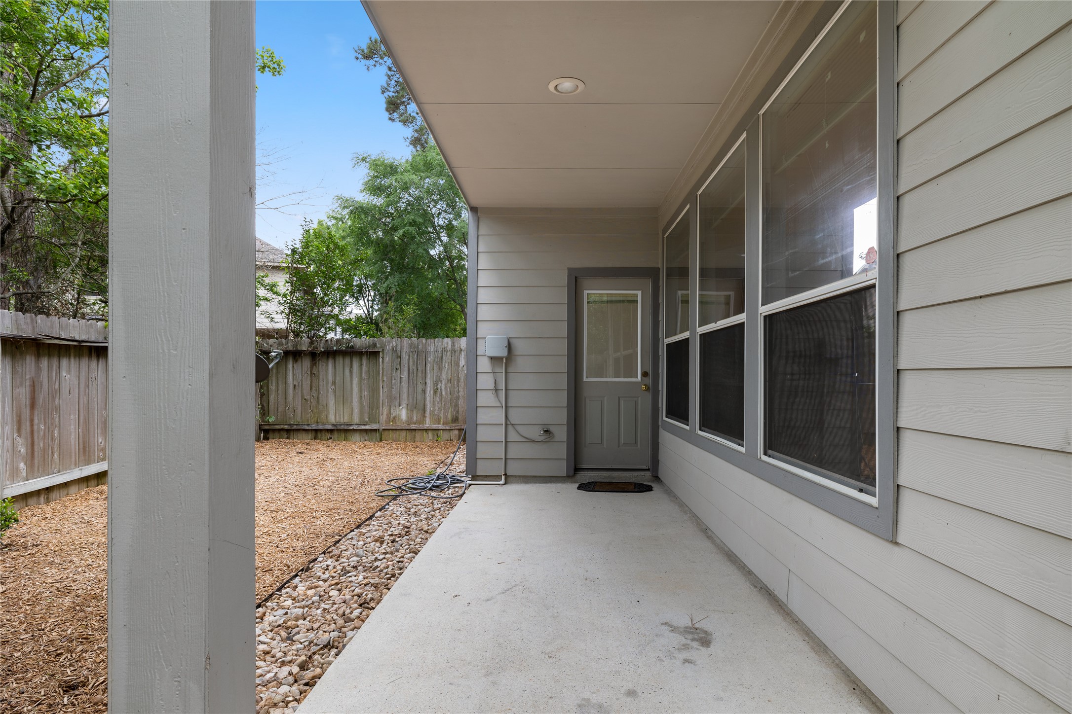 107 West Burberry Circle The Woodlands, TX 77384 - Photo 27 of 28 a view of backyard with small cabin and wooden fencing