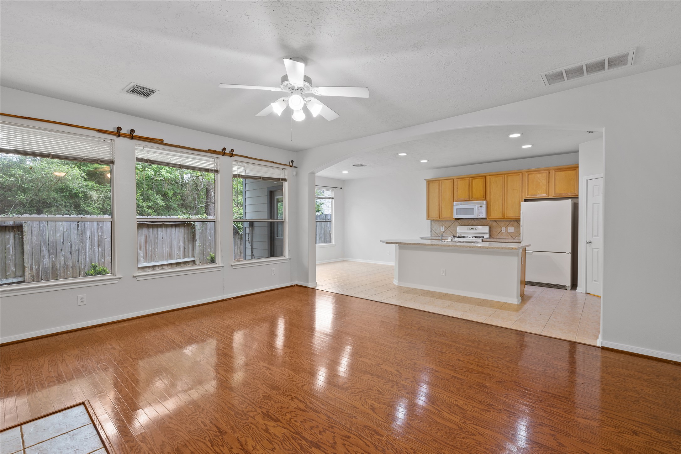 107 West Burberry Circle The Woodlands, TX 77384 - Photo 3 of 28 a view of empty room with wooden floor and fan