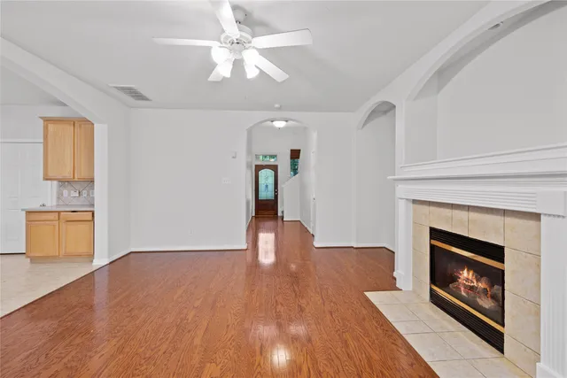 a view of an empty room with a fireplace and a window