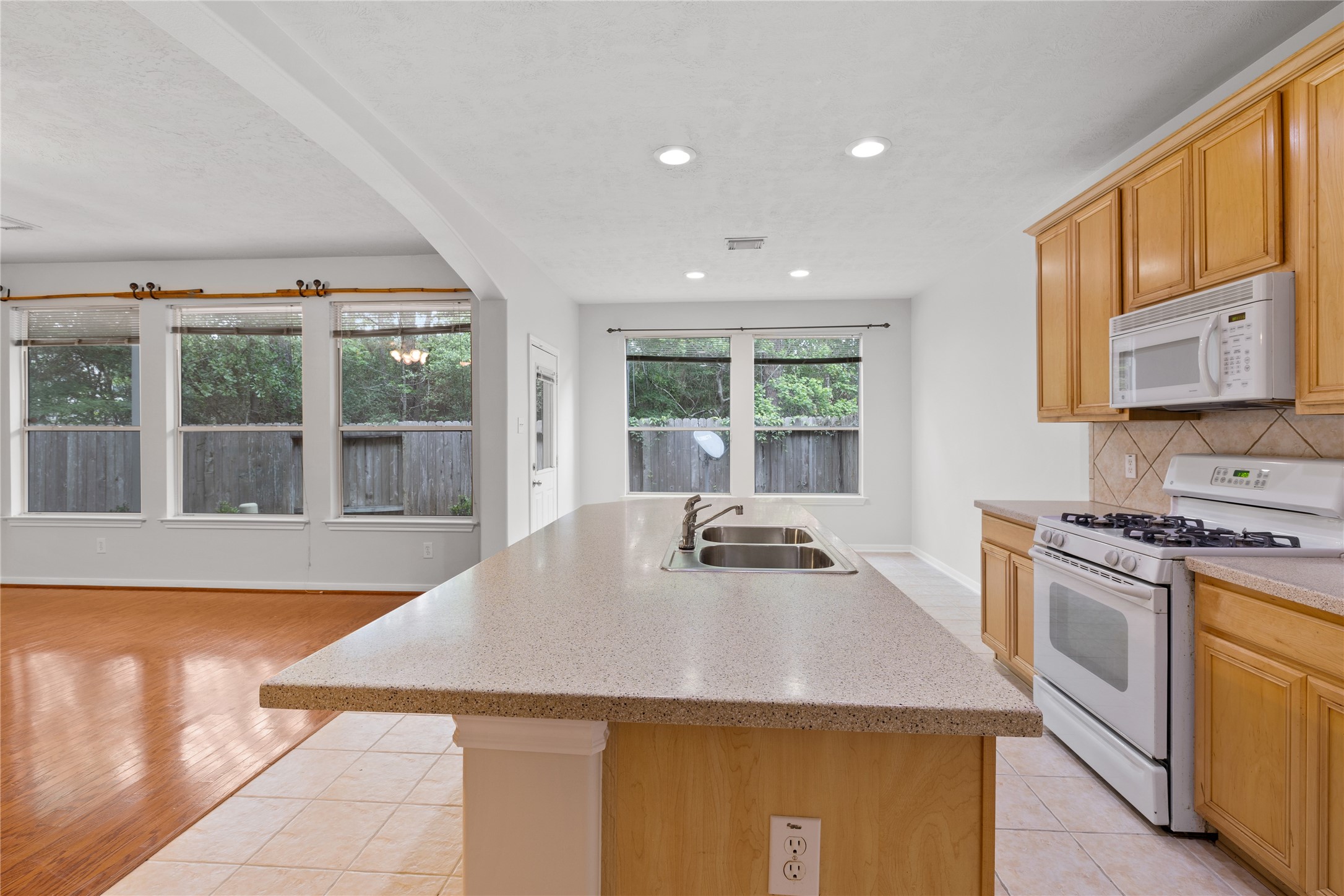 107 West Burberry Circle The Woodlands, TX 77384 - Photo 7 of 28 a kitchen with a stove a sink and a refrigerator
