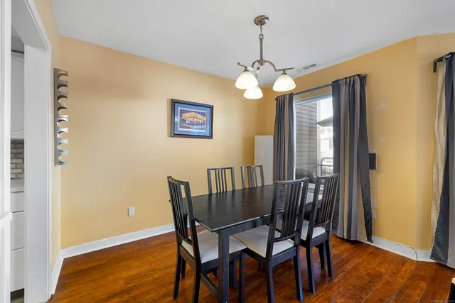 a view of a dining room with furniture wooden floor and chandelier