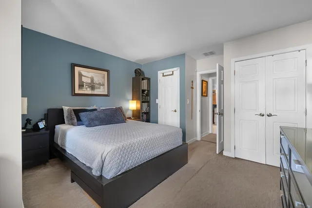 a bedroom with a bed and wall painting