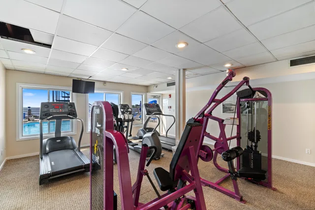 a living room with kitchen view and wooden floor