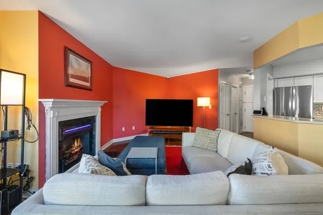 a living room with fireplace furniture and a flat screen tv