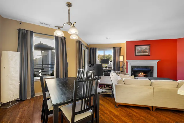 a living room with furniture a fireplace and a chandelier