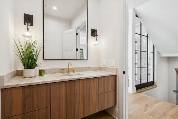 a bathroom with double vanity sinks and a mirror