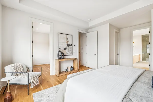 an empty room with a window and wooden floor
