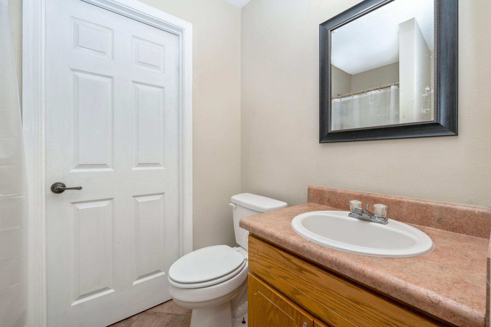 384 John King Road Crestview, FL 32539 - Photo 13 of 19 a bathroom with a granite countertop sink toilet and mirror