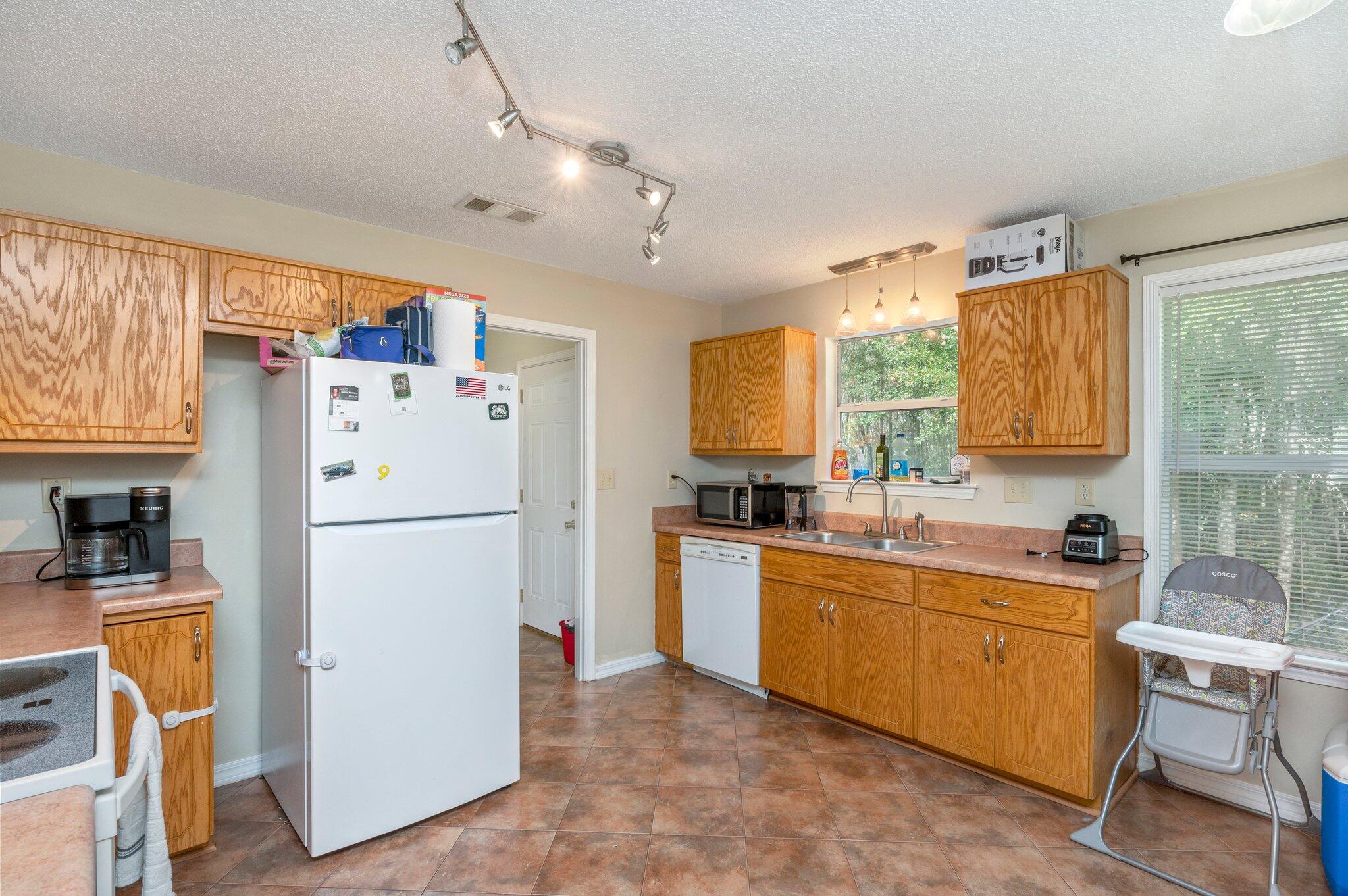 384 John King Road Crestview, FL 32539 - Photo 16 of 19 a room with furniture a refrigerator and a sink