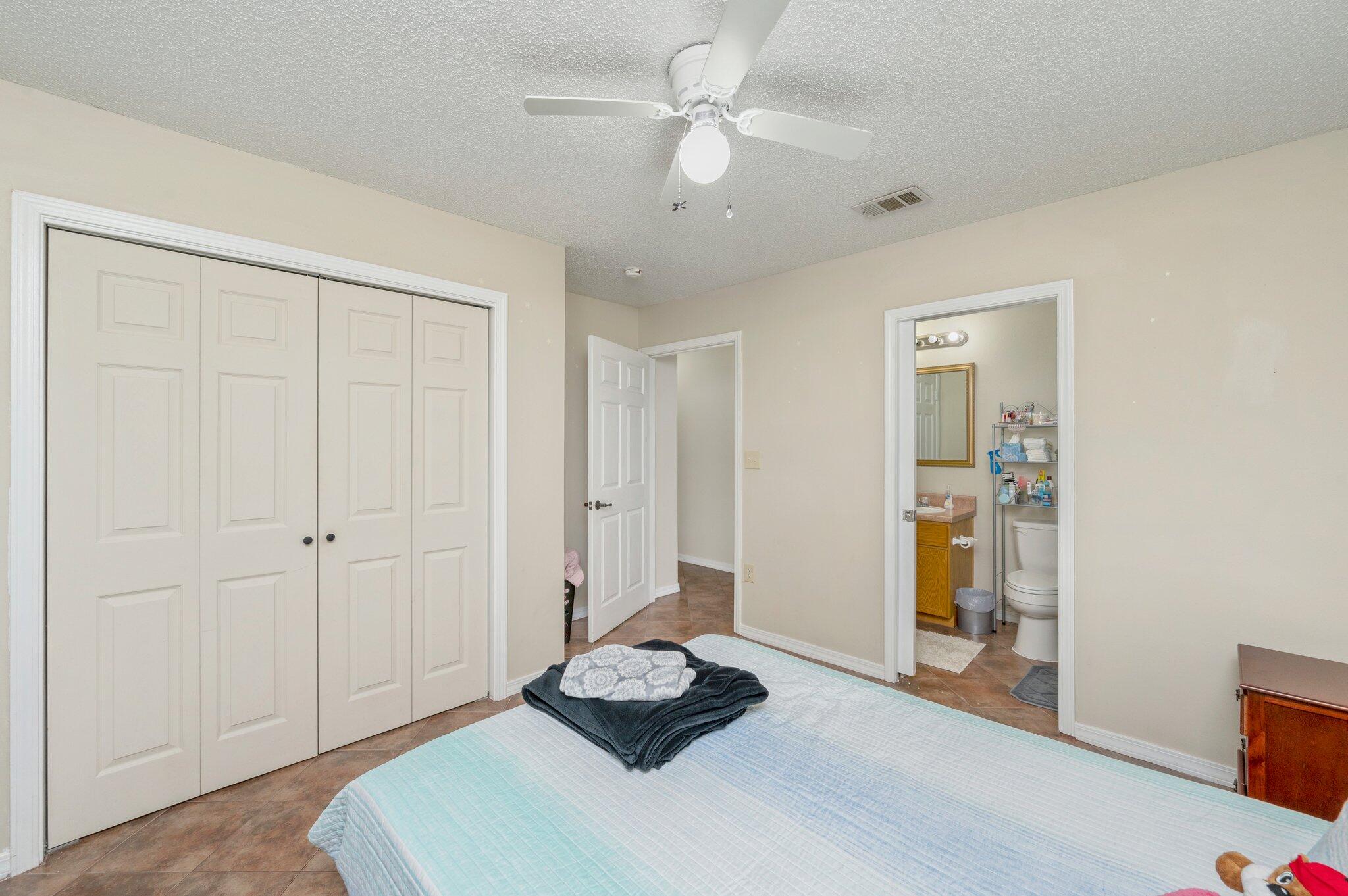 384 John King Road Crestview, FL 32539 - Photo 19 of 19 a living room with a bed and a chandelier