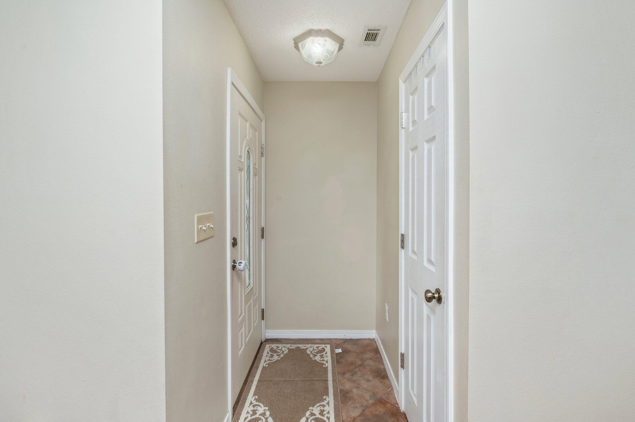 384 John King Road Crestview, FL 32539 - Photo 5 of 19 a view of a hallway with wooden floor and a bathroom