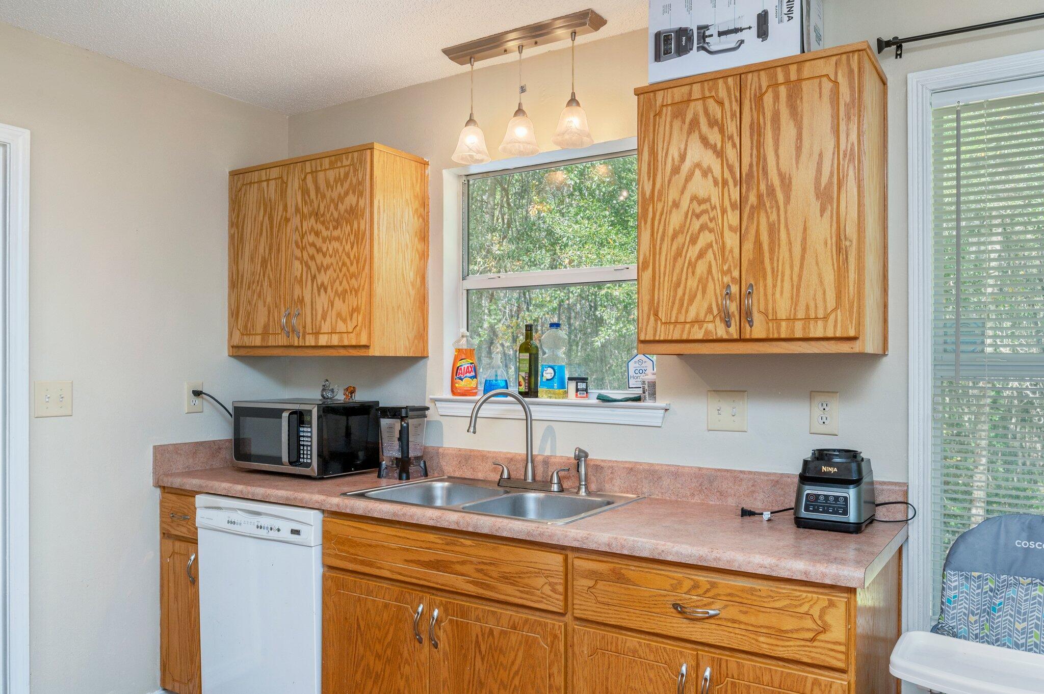 384 John King Road Crestview, FL 32539 - Photo 7 of 19 a kitchen with stainless steel appliances granite countertop sink stove and cabinets