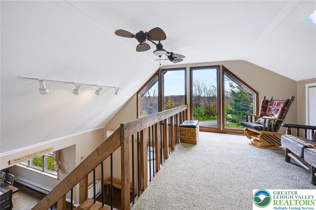 1605 Ridgeview Drive Lake Ariel, PA 18436 - Photo 23 of 40 An upper loft overlooks the lower level through a wooden railing beneath vaulted ceilings.