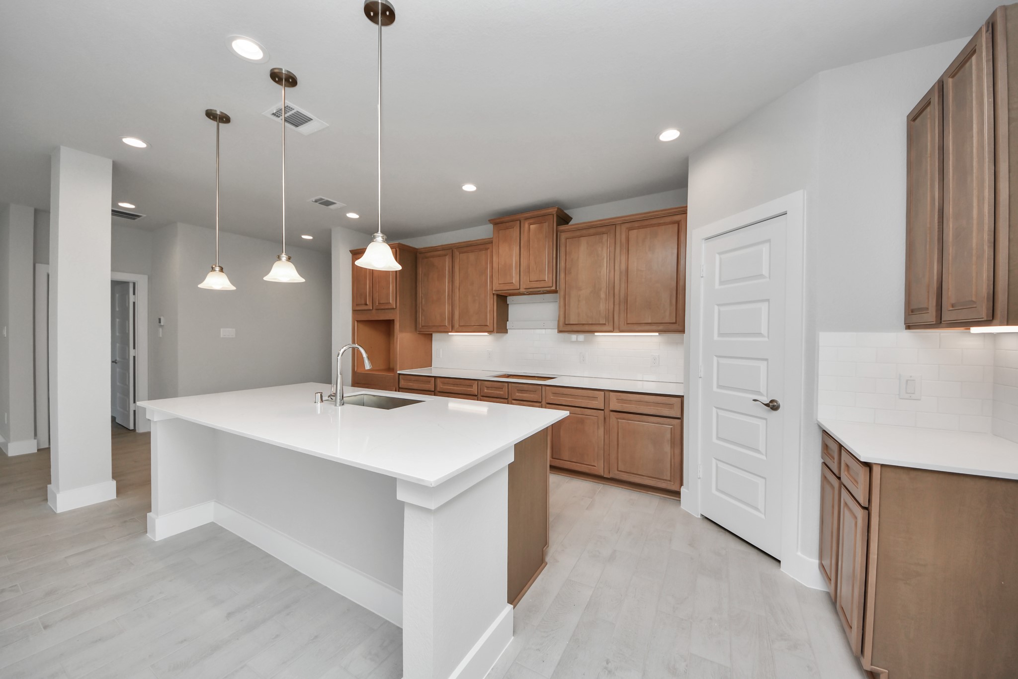 3102 Native Spg Drive Spring, TX 77373 - Photo 13 of 40 The extended counter area adds both practicality and style, making meal preparation a breeze. Every detail is thoughtfully designed to enhance the kitchen's functionality and aesthetic appeal. Sample photo of completed home with similar floor plan. Actual colors and selections may vary.