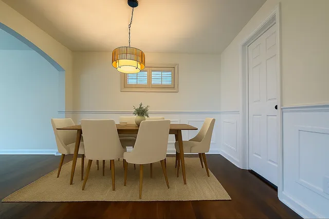a view of empty room with wooden floor and window