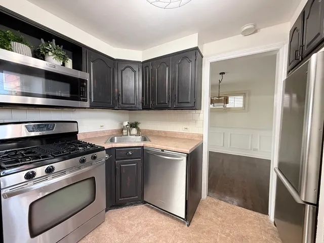 a kitchen that has a sink and a stove in it