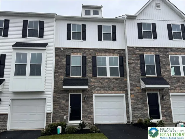 a front view of a house with stairs